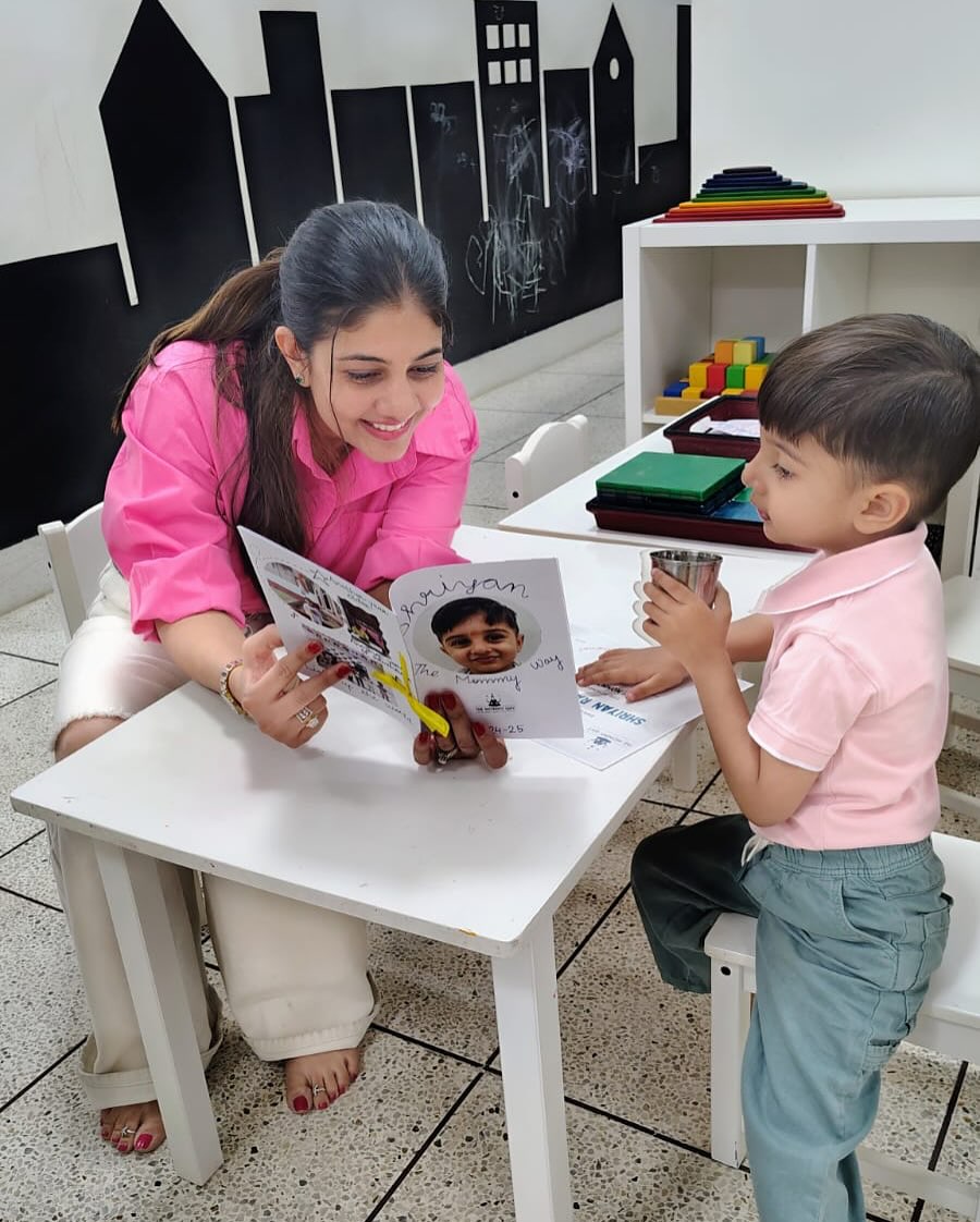 A teacher and a little one reading a picture book together at The Mommy Way play school, Ratanada, Jodhpur